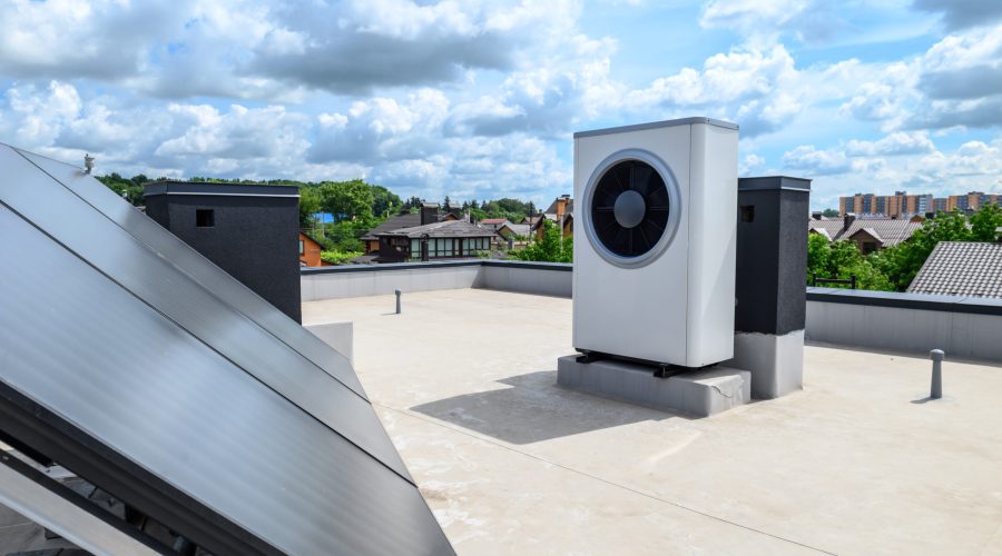 Heat pump and solar collector on the roof of the house. A system using an alternative energy source for heating water.